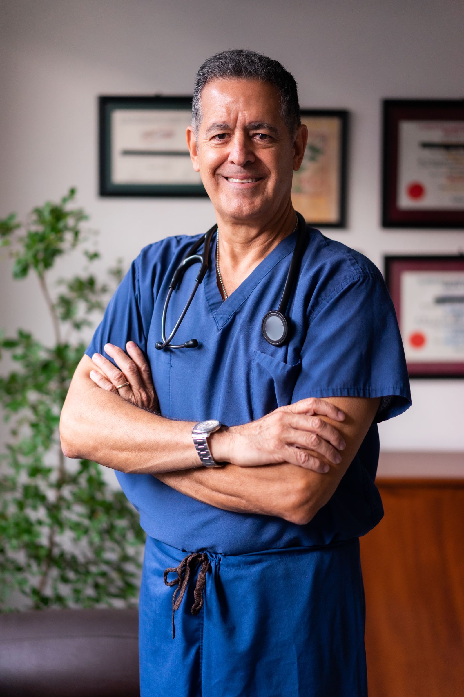 Smiling clinician in scrubs with a stethoscope. Illustrative stock photograph, not an endorsement.