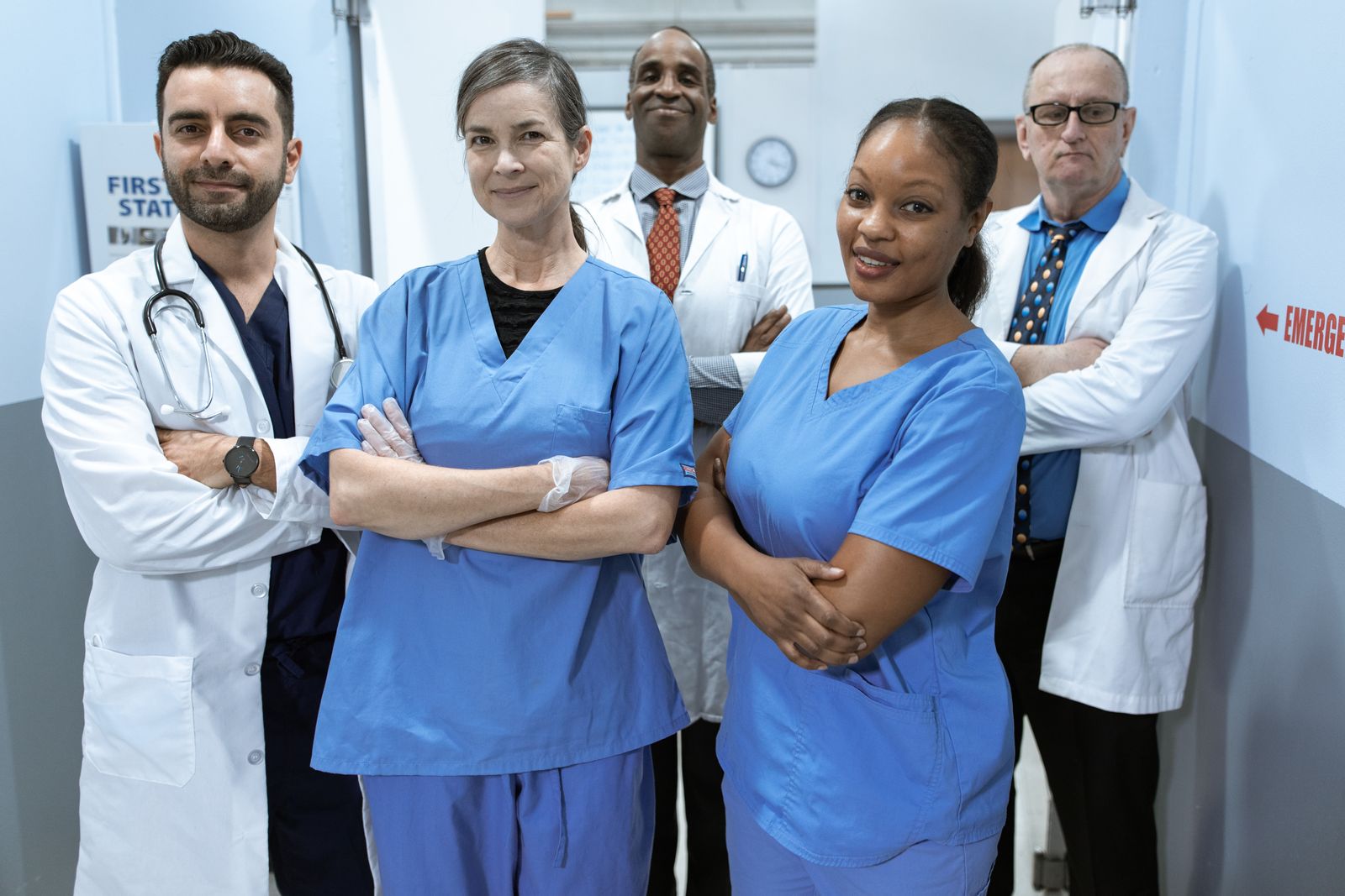 Clinical team standing in a hospital corridor.