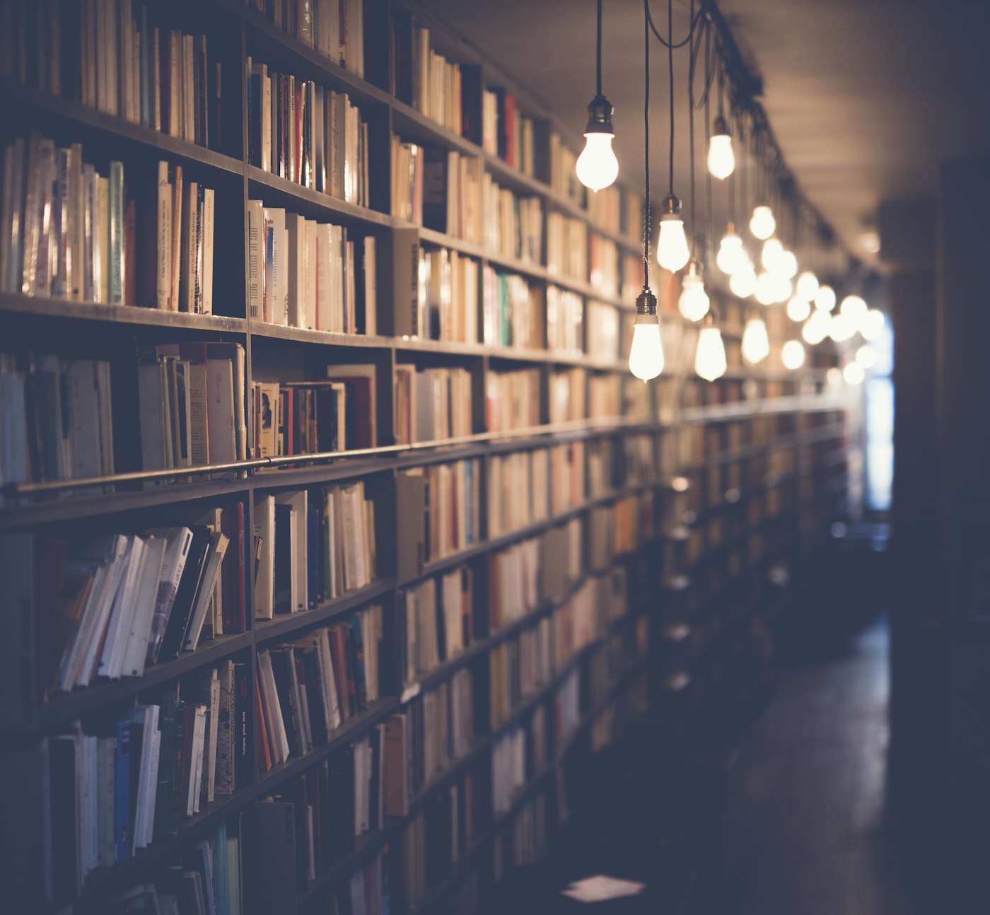 Library shelves, suggesting study for a recruitment exam.